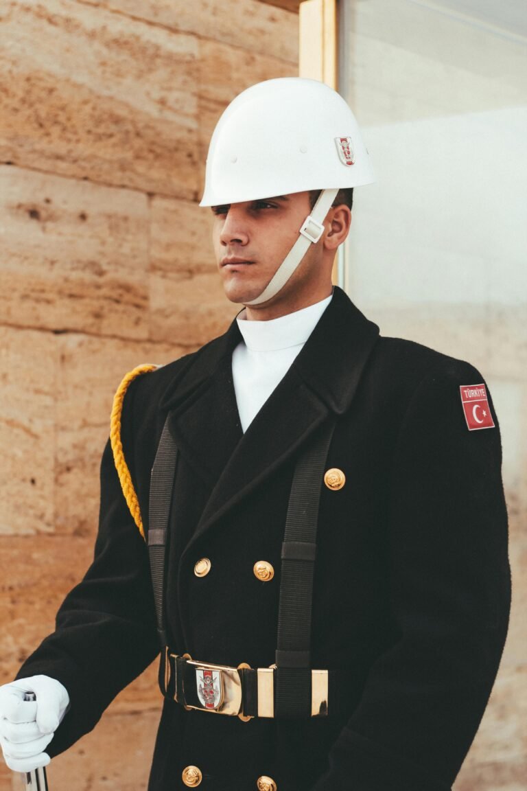 A solemn guard in ceremonial attire stands on duty with a focused expression.